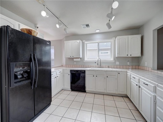 kitchen featuring white cabinets, rail lighting, a sink, and black appliances