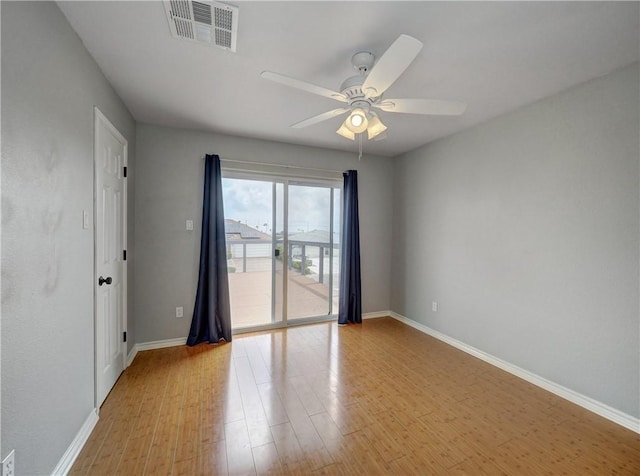 unfurnished room with visible vents, a ceiling fan, light wood-style flooring, and baseboards