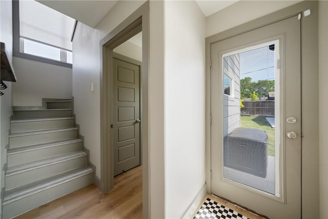 interior space with stairway, a wealth of natural light, and baseboards