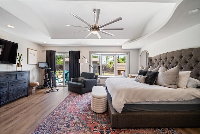 bedroom featuring ceiling fan, recessed lighting, wood finished floors, and access to exterior