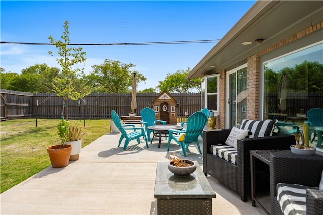 view of patio / terrace featuring an outdoor living space with a fire pit and a fenced backyard