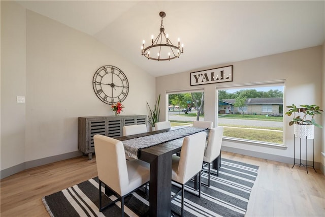 dining room with vaulted ceiling, baseboards, a chandelier, and light wood finished floors