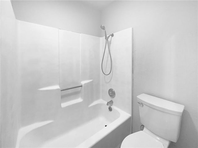 bathroom with toilet and shower / washtub combination