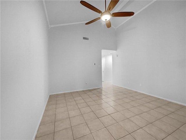 tiled empty room with ceiling fan, high vaulted ceiling, and crown molding