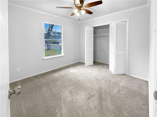 unfurnished bedroom with a closet, ceiling fan, crown molding, and light carpet