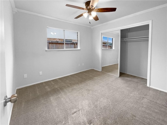 unfurnished bedroom with ceiling fan, a closet, crown molding, and carpet floors