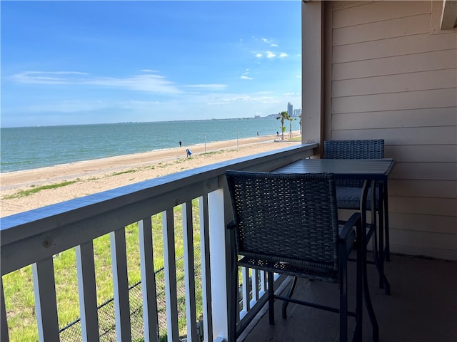 balcony with a beach view and a water view