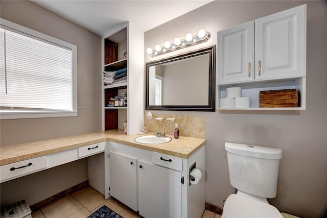 bathroom with toilet, tile patterned floors, and vanity