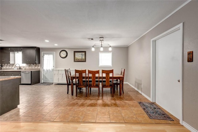 dining space with plenty of natural light, visible vents, ornamental molding, and baseboards