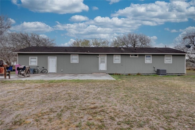 rear view of house featuring a yard, a patio area, and cooling unit