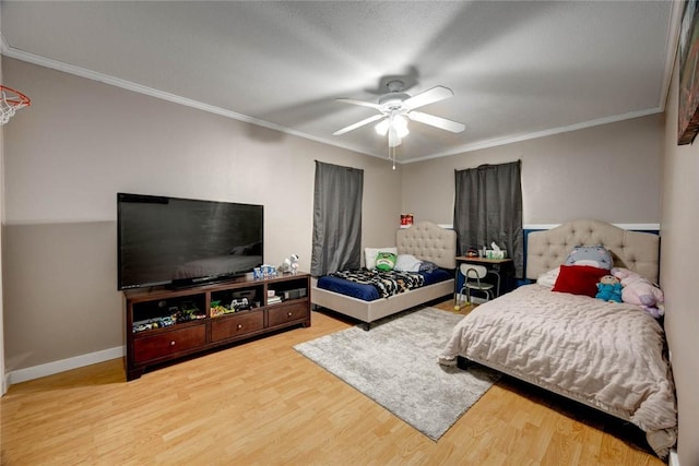 bedroom featuring ornamental molding, wood finished floors, a ceiling fan, and baseboards