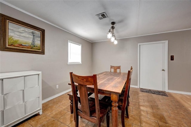 dining area with ornamental molding, visible vents, and baseboards