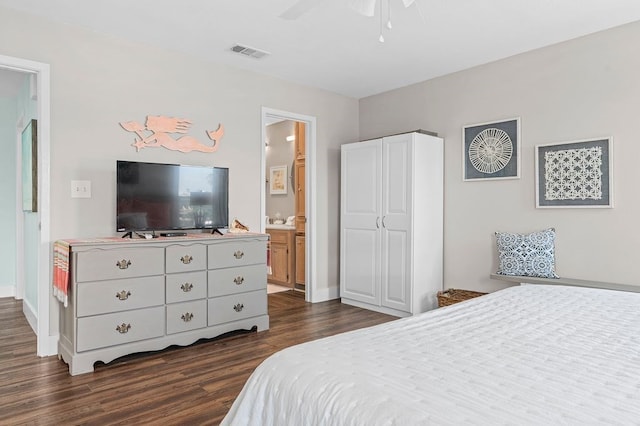 bedroom with dark wood-type flooring, ceiling fan, and connected bathroom