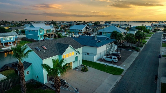 aerial view at dusk with a water view