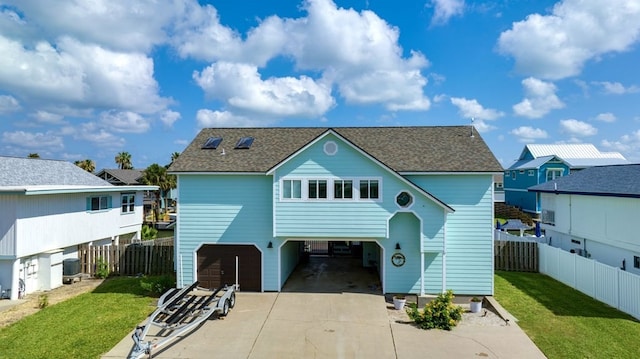 back of property with a yard and a carport