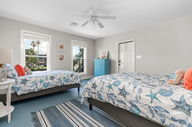 carpeted bedroom featuring ceiling fan and a closet