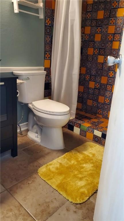 bathroom featuring tile patterned floors and toilet