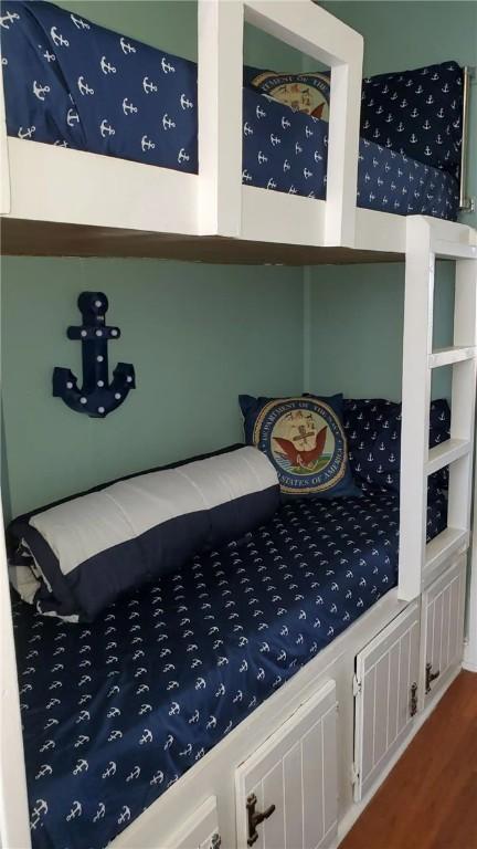 bedroom with wood-type flooring