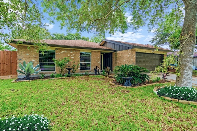 ranch-style home with a front lawn and a garage