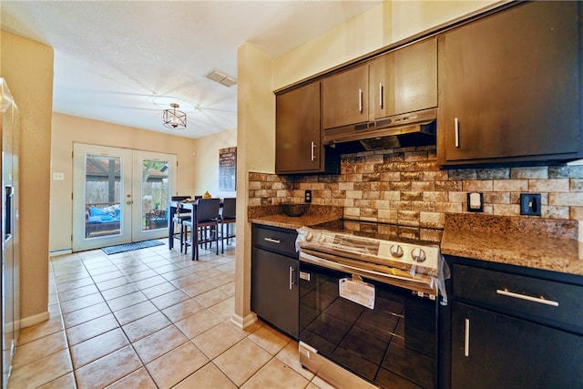 5213 Inverness Dr, Corpus Christi, TX 78413 - kitchen with electric range, under cabinet range hood, backsplash, french doors, and light tile patterned flooring