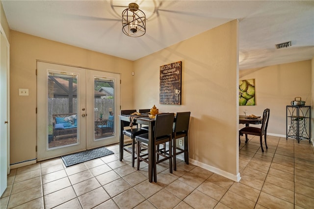 dining area with french doors and light tile patterned floors