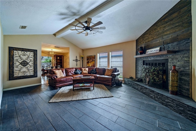 living room featuring lofted ceiling with beams, a stone fireplace, a textured ceiling, and dark hardwood / wood-style floors