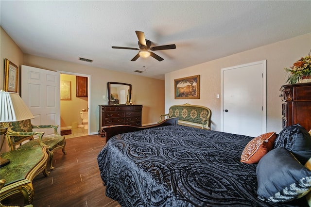 bedroom with ensuite bathroom, ceiling fan, dark hardwood / wood-style floors, and a textured ceiling