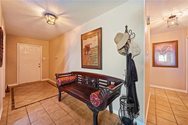 entryway featuring a textured ceiling and light tile patterned flooring