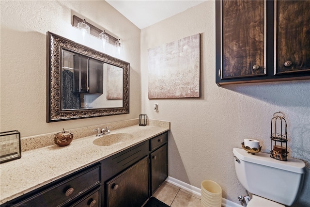 bathroom featuring toilet, vanity, and tile patterned floors