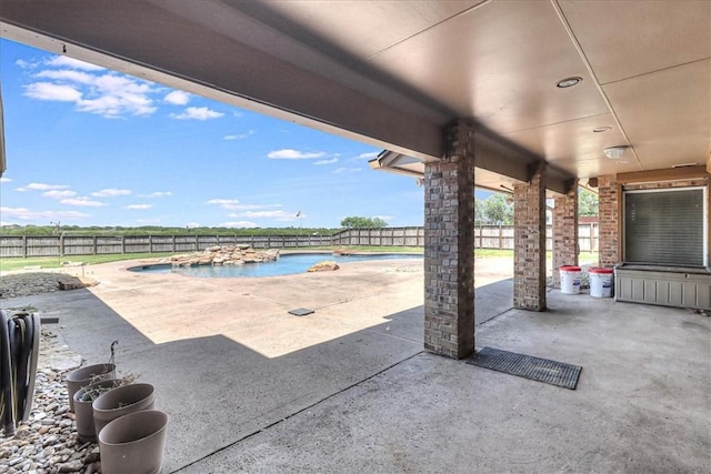 view of patio with pool water feature and a fenced in pool