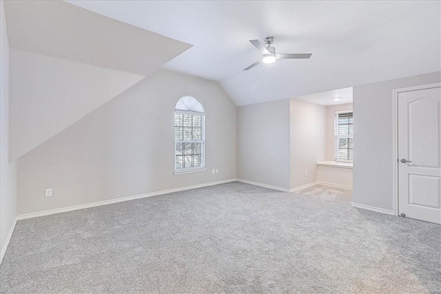 bonus room with ceiling fan, light carpet, and vaulted ceiling