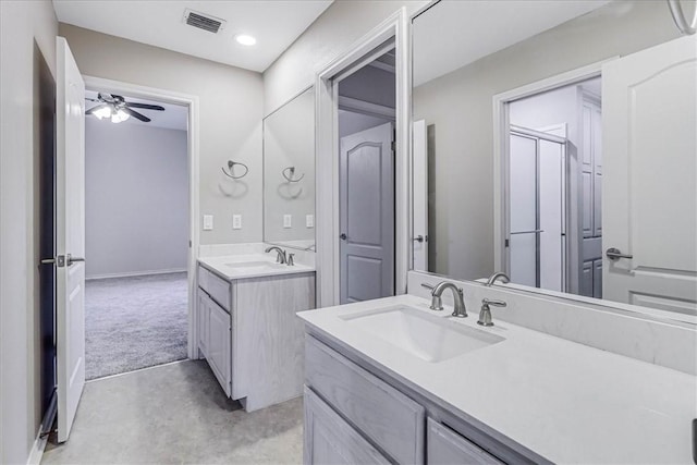 bathroom with ceiling fan, an enclosed shower, and vanity