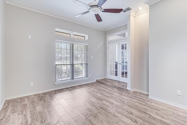 empty room with ceiling fan, light hardwood / wood-style floors, crown molding, and french doors