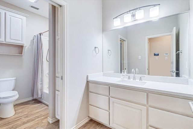 full bathroom featuring vanity, toilet, shower / bathtub combination with curtain, and wood-type flooring