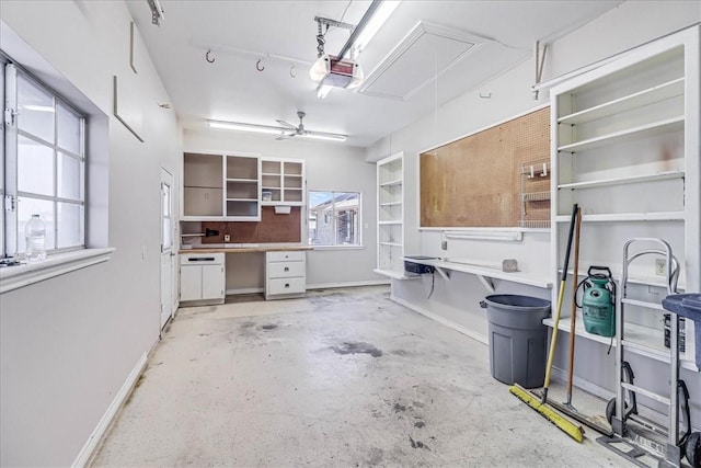 garage with ceiling fan and a garage door opener