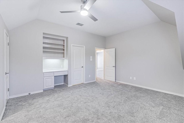 unfurnished bedroom featuring ceiling fan, lofted ceiling, and light carpet