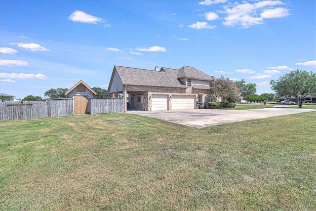 exterior space featuring a lawn and a garage