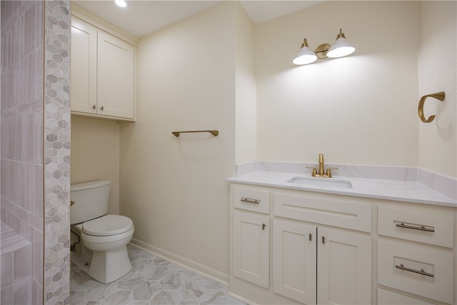 bathroom with toilet and vanity