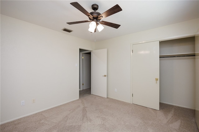 unfurnished bedroom featuring light colored carpet, ceiling fan, and a closet