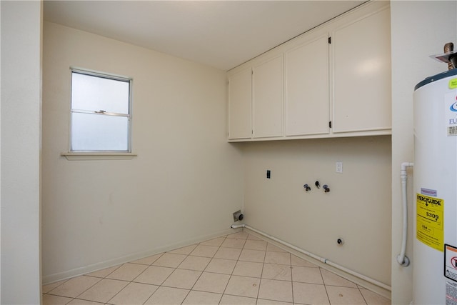 clothes washing area with washer hookup, light tile patterned floors, water heater, cabinets, and electric dryer hookup