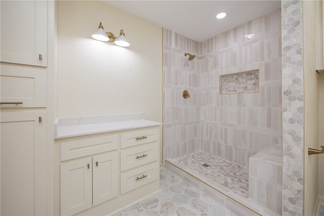 bathroom featuring vanity and a tile shower