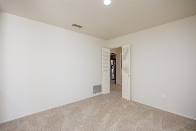 empty room with light colored carpet