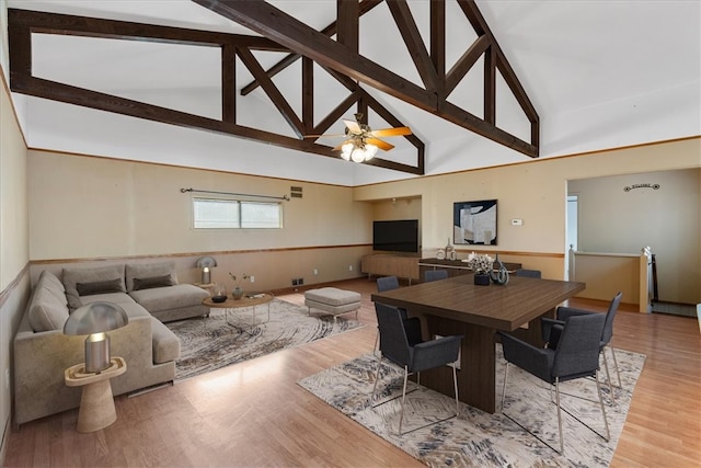 dining area with high vaulted ceiling, hardwood / wood-style floors, ceiling fan, and beam ceiling