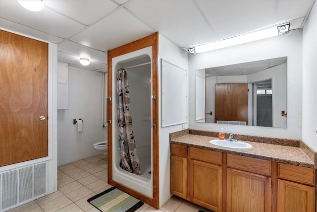 bathroom featuring vanity, curtained shower, tile patterned flooring, and toilet