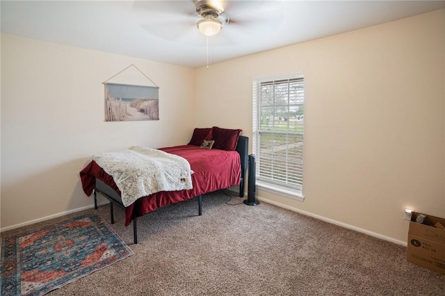 carpeted bedroom featuring baseboards and a ceiling fan