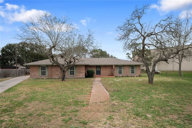 ranch-style home with brick siding, a front yard, and fence