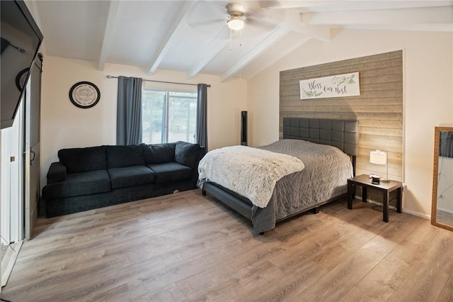 bedroom with lofted ceiling with beams, light wood finished floors, baseboards, and a ceiling fan