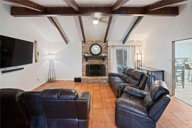 tiled living area with a ceiling fan, a brick fireplace, lofted ceiling with beams, and baseboards