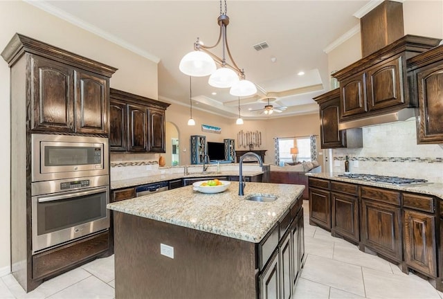 kitchen with stainless steel appliances, visible vents, a sink, and crown molding