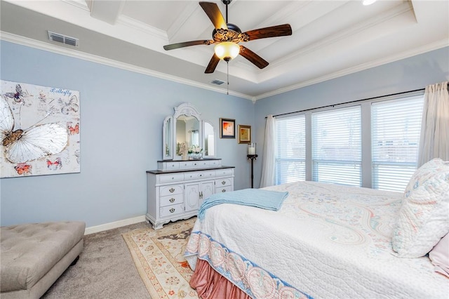 bedroom featuring a tray ceiling, light carpet, crown molding, and visible vents